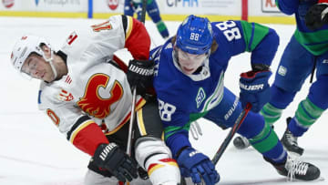 VANCOUVER, BC - FEBRUARY 8: Adam Gaudette #88 of the Vancouver Canucks checks Derek Ryan #10 of the Calgary Flames during their NHL game at Rogers Arena February 8, 2020 in Vancouver, British Columbia, Canada. (Photo by Jeff Vinnick/NHLI via Getty Images)