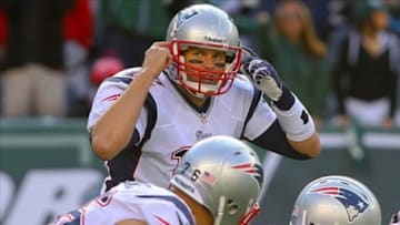 Oct 20, 2013; East Rutherford, NJ, USA; New England Patriots quarterback Tom Brady (12) calls signals during the second half of their game against the New York Jets at MetLife Stadium. The Jets defeated the Patriots 30-27 in overtime. Mandatory Credit: Ed Mulholland-USA TODAY Sports