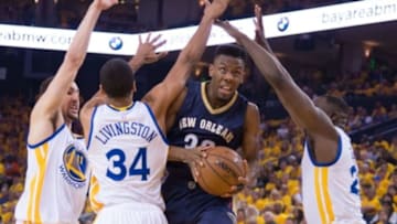 April 18, 2015; Oakland, CA, USA; New Orleans Pelicans guard Norris Cole (30, second from right) drives to the basket against Golden State Warriors guard Klay Thompson (11), guard Shaun Livingston (34), and forward Draymond Green (23, far right) during the second quarter in game one of the second round of the NBA Playoffs at Oracle Arena. Mandatory Credit: Kyle Terada-USA TODAY Sports