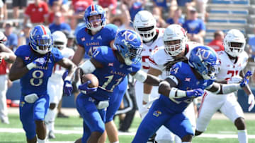 LAWRENCE, KS - SEPTEMBER 15: Safety Mike Lee #11 of the Kansas Jayhawks gets a block by cornerback Ricky Thomas #24 as he runs back an interception for a touchdown against the Rutgers Scarlet Knights in the second quarter at Memorial Stadium on September 15, 2018 in Lawrence, Kansas. (Photo by Ed Zurga/Getty Images)
