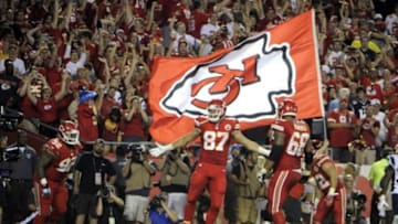 Sep 29, 2014; Kansas City, MO, USA; Kansas City Chiefs tight end Travis Kelce (87) celebrates with nose tackle Dontari Poe (92) and tackle Ryan Harris (68) after scoring a touchdown against the New England Patriots in the second half at Arrowhead Stadium. Kansas City won 41-14. Mandatory Credit: John Rieger-USA TODAY Sports