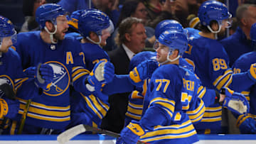 Oct 4, 2022; Buffalo, New York, USA; Buffalo Sabres right wing JJ Peterka (77) celebrates his goal with teammates during the third period against the Carolina Hurricanes at KeyBank Center. Mandatory Credit: Timothy T. Ludwig-USA TODAY Sports