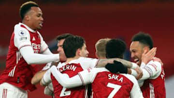 Arsenal's Gabonese striker Pierre-Emerick Aubameyang (R) celebrates scoring the opening goal during the English Premier League football match between Arsenal and Leeds United at the Emirates Stadium in London on February 14, 2021. (Photo by Catherine Ivill / POOL / AFP) / RESTRICTED TO EDITORIAL USE. No use with unauthorized audio, video, data, fixture lists, club/league logos or 'live' services. Online in-match use limited to 120 images. An additional 40 images may be used in extra time. No video emulation. Social media in-match use limited to 120 images. An additional 40 images may be used in extra time. No use in betting publications, games or single club/league/player publications. / (Photo by CATHERINE IVILL/POOL/AFP via Getty Images)