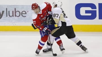 Mar 1, 2016; Washington, DC, USA; Washington Capitals right wing T.J. Oshie (77) passes the puck while being checked by Pittsburgh Penguins center Sidney Crosby (87) in the second period at Verizon Center. Mandatory Credit: Geoff Burke-USA TODAY Sports