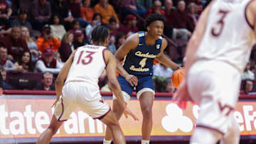 BLACKSBURG, VA - NOVEMBER 25: Guard Tyeree Bryan #4 of the Charleston Southern Buccaneers dribbles past guard Darius Maddox #13 of the Virginia Tech Hokies during the first half at Cassell Coliseum on November 25, 2022 in Blacksburg, Virginia. (Photo by Ryan Hunt/Getty Images)