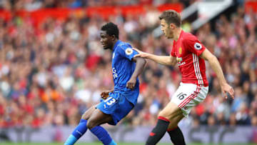Daniel Amartey of Leicester City (L) passes the ball while under pressure from Michael Carrick of Manchester United (R) (Photo by Clive Brunskill/Getty Images)