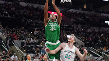 Nov 26, 2021; San Antonio, Texas, USA; Boston Celtics center Al Horford (42) shoots over San Antonio Spurs center Jakob Poeltl (25) in the first half at the AT&T Center. Mandatory Credit: Daniel Dunn-USA TODAY Sports