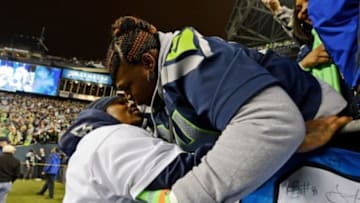 Jan 19, 2014; Seattle, WA, USA; Seattle Seahawks running back Marshawn Lynch (left) kisses his mother Delisa Lynch (right) after the 2013 NFC Championship football game against the San Francisco 49ers at CenturyLink Field. Mandatory Credit: Kyle Terada-USA TODAY Sports
