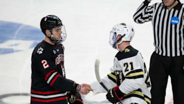 WORCESTER, MA - MARCH 25: Josh Passolt #21 of the Western Michigan Broncos shakes hands with Jordan Harris #2 of the Northeastern Huskies after the NCAA Men's Ice Hockey Northeast Regional game at the DCU Center on March 25, 2022 in Worcester, Massachusetts. The Broncos won 2-1 in overtime. (Photo by Richard T Gagnon/Getty Images)