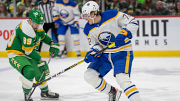 Jan 28, 2023; Saint Paul, Minnesota, USA; Buffalo Sabres center Tage Thompson (72) has the puck stolen by Minnesota Wild center Frederick Gaudreau (89) in the third period at Xcel Energy Center. Mandatory Credit: Matt Blewett-USA TODAY Sports