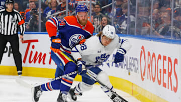 Mar 1, 2023; Edmonton, Alberta, CAN; Toronto Maple Leafs forward William Nylander (88) and Edmonton Oilers defensemen Mattias Ekholm (14) battle along the boards for a loose puck during the second period at Rogers Place. Mandatory Credit: Perry Nelson-USA TODAY Sports