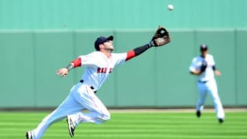 Mar 10, 2014; Fort Myers, FL, USA; Boston Red Sox second baseman Dustin Pedroia (15) attempts to make a diving catch during the 3rd inning against the Tampa Bay Rays at JetBlue Park. Mandatory Credit: Andrew Weber-USA TODAY Sports