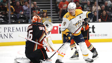 ANAHEIM, CALIFORNIA - MARCH 21: John Gibson #36 of the Anaheim Ducks stops a shot on goal ass Filip Forsberg #9 of the Nashville Predators looks for a rebound during the second period of a game at Honda Center on March 21, 2022 in Anaheim, California. (Photo by Sean M. Haffey/Getty Images)