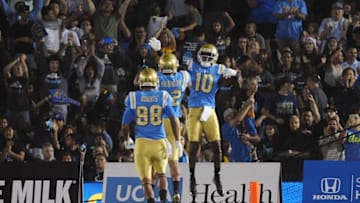 October 1, 2016; Pasadena, CA, USA; UCLA Bruins wide receiver Kenneth Walker III (10) celebrates with wide receiver Eldridge Massington (82) and tight end Austin Roberts (88) after scoring a touchdown against the Arizona Wildcats during the first half at Rose Bowl. Mandatory Credit: Gary A. Vasquez-USA TODAY Sports