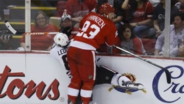 May 20, 2013; Detroit, MI, USA; Detroit Red Wings left wing Johan Franzen (93) checks Chicago Blackhawks defenseman Nick Leddy (8) into the wall in the first period in game three of the second round of the 2013 Stanley Cup Playoffs at Joe Louis Arena. Mandatory Credit: Rick Osentoski-USA TODAY Sports