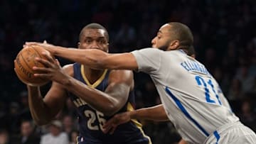 Apr 3, 2016; Brooklyn, NY, USA; Brooklyn Nets guard Wayne Ellington (21) tries to block New Orleans Pelicans guard Jordan Hamilton (25) in the first half at Barclays Center. Mandatory Credit: William Hauser-USA TODAY Sports