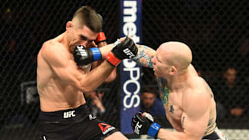 WINNIPEG, CANADA - DECEMBER 16: (R-L) Josh Emmett punches Ricardo Lamas in their featherweight bout during the UFC Fight Night event at Bell MTS Place on December 16, 2017 in Winnipeg, Manitoba, Canada. (Photo by Josh Hedges/Zuffa LLC/Zuffa LLC via Getty Images)