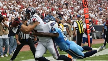 Sep 15, 2013; Houston, TX, USA; Houston Texans tight end Owen Daniels (81) scores a third quarter touchdown against Tennessee Titans safety Bernard Pollard (31) at Reliant Stadium. Mandatory Credit: Matthew Emmons-USA TODAY Sports