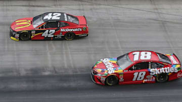 BRISTOL, TN - APRIL 16: Kyle Busch, driver of the #18 Skittles Toyota, and Kyle Larson, driver of the #42 McDonald's Chevrolet (Photo by Matt Sullivan/Getty Images)