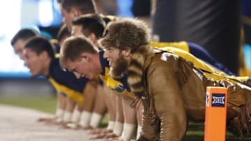 Sep 6, 2014; Morgantown, WV, USA; The West Virginia Mountaineers cheerleaders and mascot do push-ups after a Mountaineer touchdown against the Towson Tigers during the fourth quarter at Milan Puskar Stadium.West Virginia won 54-0. Mandatory Credit: Charles LeClaire-USA TODAY Sports