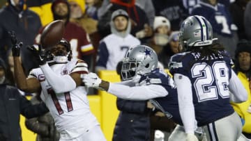 Jan 8, 2023; Landover, Maryland, USA; Washington Commanders wide receiver Terry McLaurin (17) catches a pass as Dallas Cowboys cornerback Trayvon Mullen (37) defends during the fourth quarter at FedExField. Mandatory Credit: Geoff Burke-USA TODAY Sports