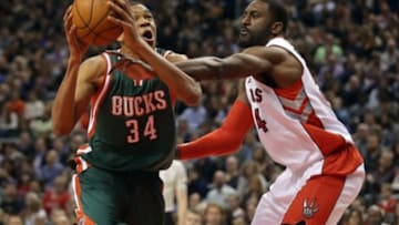 Nov 21, 2014; Toronto, Ontario, CAN; Milwaukee Bucks guard Giannis Antetokounmpo (34) is fouled on his way to the basket by Toronto Raptors forward Patrick Patterson (54) at Air Canada Centre. Mandatory Credit: Tom Szczerbowski-USA TODAY Sports