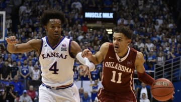 LAWRENCE, KS - FEBRUARY 19: Trae Young #11 of the Oklahoma Sooners drives to the basket as he is defended by Devonte' Graham #4 of the Kansas Jayhawks in the second half at Allen Fieldhouse on February 19, 2018 in Lawrence, Kansas. (Photo by Ed Zurga/Getty Images)