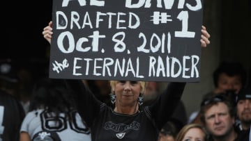 OAKLAND, CA - OCTOBER 16: An Oakland Raiders fan hold up a sign in honor of the late owner Al Davis before the game against the Cleveland Browns at O.co Coliseum on October 16, 2011 in Oakland, California. (Photo by Thearon W. Henderson/Getty Images)