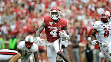 NORMAN, OK - SEPTEMBER 28: Running back Trey Sermon #4 of the Oklahoma Sooners scrambles against the defense of the Texas Tech Red Raiders at Gaylord Family Oklahoma Memorial Stadium on September 28, 2019 in Norman, Oklahoma. The Sooners defeated the Red Raiders 55-16. (Photo by Brett Deering/Getty Images)