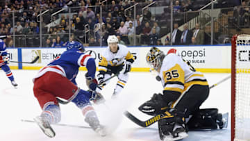 NEW YORK, NEW YORK - APRIL 07: Tristan Jarry #35 of the Pittsburgh Penguins makes a chest save on Filip Chytil #72 of the New York Rangers during the first period at Madison Square Garden on April 07, 2022 in New York City. (Photo by Bruce Bennett/Getty Images)