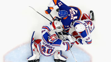 UNIONDALE, NEW YORK - APRIL 09: Adam Fox #23 and Alexandar Georgiev #40 of the New York Rangers defend the net against Matt Martin #17 of the New York Islanders at Nassau Coliseum on April 09, 2021 in Uniondale, New York. The Rangers defeated the Islanders 4-1. (Photo by Bruce Bennett/Getty Images)