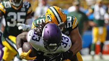 GREEN BAY, WI - SEPTEMBER 16: Blake Martinez #50 of the Green Bay Packers tackles Dalvin Cook #33 of the Minnesota Vikings at Lambeau Field on September 16, 2018 in Green Bay, Wisconsin. The Vikings and the Packers tied 29-29 after overtime. (Photo by Jonathan Daniel/Getty Images)