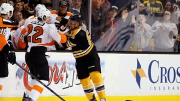 Oct 8, 2014; Boston, MA, USA; Boston Bruins center Bobby Robins (64) fights with Philadelphia Flyers defenseman Luke Schenn (22) during the second period at TD Banknorth Garden. Mandatory Credit: Greg M. Cooper-USA TODAY Sports
