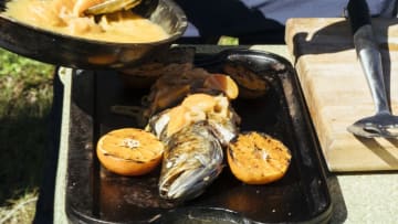 Louisiana - Grilled fish finished with satsuma beurre blanc during the big cook. (Credit: National Geographic/Rush Jagoe)