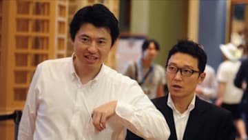 Dec 11, 2013; Orlando, FL, USA; Rakuten Golden Eagles president Yozo Tachibana (right) walks through the lobby during the MLB Winter Meetings at the Walt Disney World Swan and Dolphin Resort. Tachibana has not decided whether or not to allow Masahiro Tanaka (not pictured) to sign with a MLB team now that Nippon Professional Baseball and the MLB have agreed on a $20 Million maximum posting bid. Mandatory Credit: David Manning-USA TODAY Sports