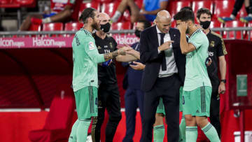 GRANADA, SPAIN - JULY 13: (L-R) Sergio Ramos of Real Madrid, coach Zinedine Zidane of Real Madrid, Marco Asensio of Real Madrid during the La Liga Santander match between Granada v Real Madrid at the Estadio Nuevo Los Cármenes on July 13, 2020 in Granada Spain (Photo by David S. Bustamante/Soccrates/Getty Images)
