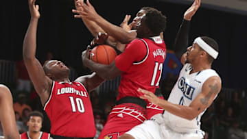 Nov 23, 2016; Paradise Island, BAHAMAS; Louisville Cardinals forward Mangok Mathiang (12) and forward Jaylen Johnson (10) battle for the ball with Old Dominion Monarchs guard Jordan Baker (0) during the first half in the 2016 Battle 4 Atlantis in the Imperial Arena at the Atlantis Resort. Mandatory Credit: Kevin Jairaj-USA TODAY Sports