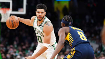 Jan 10, 2022; Boston, Massachusetts, USA; Boston Celtics forward Jayson Tatum (0) looks for an opening against Indiana Pacers forward Justin Holiday (8) in overtime at TD Garden. Mandatory Credit: David Butler II-USA TODAY Sports