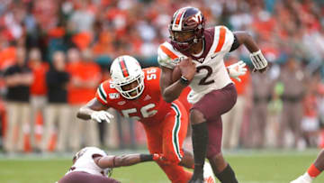 MIAMI, FLORIDA - OCTOBER 05: Hendon Hooker #2 of the Virginia Tech Hokies runs with the ball past Michael Pinckney #56 of the Miami Hurricanes during the first half at Hard Rock Stadium on October 05, 2019 in Miami, Florida. (Photo by Michael Reaves/Getty Images)