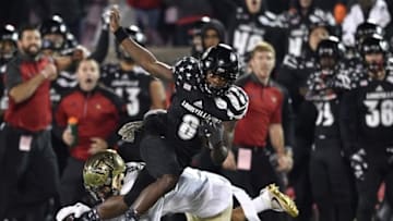 Nov 12, 2016; Louisville, KY, USA; Louisville Cardinals quarterback Lamar Jackson (8) tries to avoid the tackle of Wake Forest Demon Deacons defensive back Jessie Bates (3) during the second half at Papa John