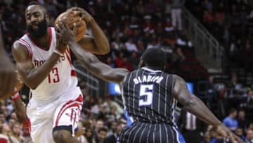 Dec 8, 2013; Houston, TX, USA; Houston Rockets shooting guard James Harden (13) drives the ball to the basket during the first quarter as Orlando Magic shooting guard Victor Oladipo (5) defends at Toyota Center. Mandatory Credit: Troy Taormina-USA TODAY Sports
