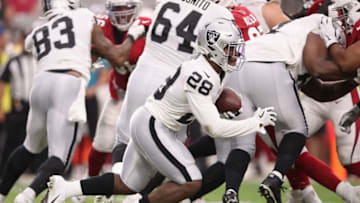 GLENDALE, ARIZONA - AUGUST 15: Running back Josh Jacobs #28 of the Oakland Raiders rushes the football against the Arizona Cardinals during the first half of the NFL preseason game at State Farm Stadium on August 15, 2019 in Glendale, Arizona. (Photo by Christian Petersen/Getty Images)