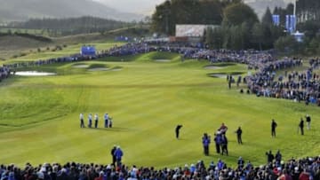Sep 27, 2014; Gleneagles, Perthshire, SCT; Ian Poulter and Rory McIlroy watch as Rickie Fowler plays his shot on the fairway at the 2nd hole during their fourball match on day two of the 2014 Ryder Cup at Gleneagles Resort - PGA Centenary Course. Mandatory Credit: Ian Rutherford-USA TODAY Sports