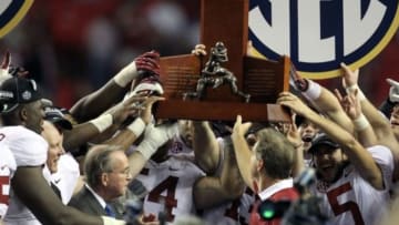 Dec 1, 2012; Atlanta, GA, USA; Alabama Crimson Tide head coach Nick Saban and his team hold the SEC trophy after winning the 2012 SEC Championship game against the Georgia Bulldogs at the Georgia Dome. Alabama won 32-28. Mandatory Credit: Daniel Shirey-USA TODAY Sports