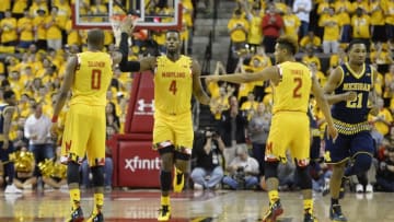 Feb 21, 2016; College Park, MD, USA; Maryland Terrapins forward Robert Carter (4) celebrates with guard Rasheed Sulaimon (0) and guard Melo Trimble (2) after scoring during the first half against the Michigan Wolverines at Xfinity Center. Mandatory Credit: Tommy Gilligan-USA TODAY Sports