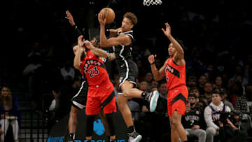 Dec 14, 2021; Brooklyn, New York, USA; Brooklyn Nets forward Kessler Edwards (14) grabs a rebound against Toronto Raptors guard Fred VanVleet (23) and forward Scottie Barnes (4) during the second quarter at Barclays Center. Mandatory Credit: Brad Penner-USA TODAY Sports