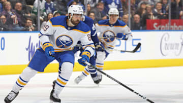 TORONTO, CANADA - MARCH 13: Alex Tuch #89 of the Buffalo Sabres grabs a puck against the Toronto Maple Leafs during an NHL game at Scotiabank Arena on March 13, 2023 in Toronto, Ontario, Canada. The Sabres defeated the Maple Leafs 4-3. (Photo by Claus Andersen/Getty Images)