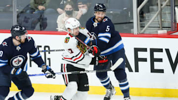 Winnipeg Jets, Brenden Dillon (5); Chicago Blackhawks, Dylan Strome (17). Mandatory Credit: Terrence Lee-USA TODAY Sports