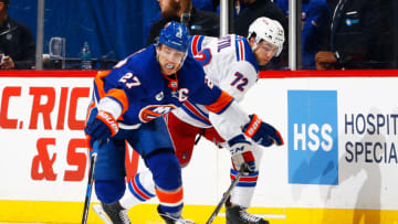 NEW YORK, NY - JANUARY 12: Anders Lee #27 of the New York Islanders plays the puck against Filip Chytil #72 of the New York Rangers at Barclays Center on January 12, 2019 the Brooklyn borough of New York City. (Photo by Mike Stobe/NHLI via Getty Images)