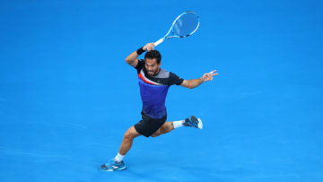 MELBOURNE, AUSTRALIA - JANUARY 15: Victor Estrella Burgos of Dominican Republic plays a forehand during his first round match against Rafael Nadal of Spain on day one of the 2018 Australian Open at Melbourne Park on January 15, 2018 in Melbourne, Australia. (Photo by Cameron Spencer/Getty Images)